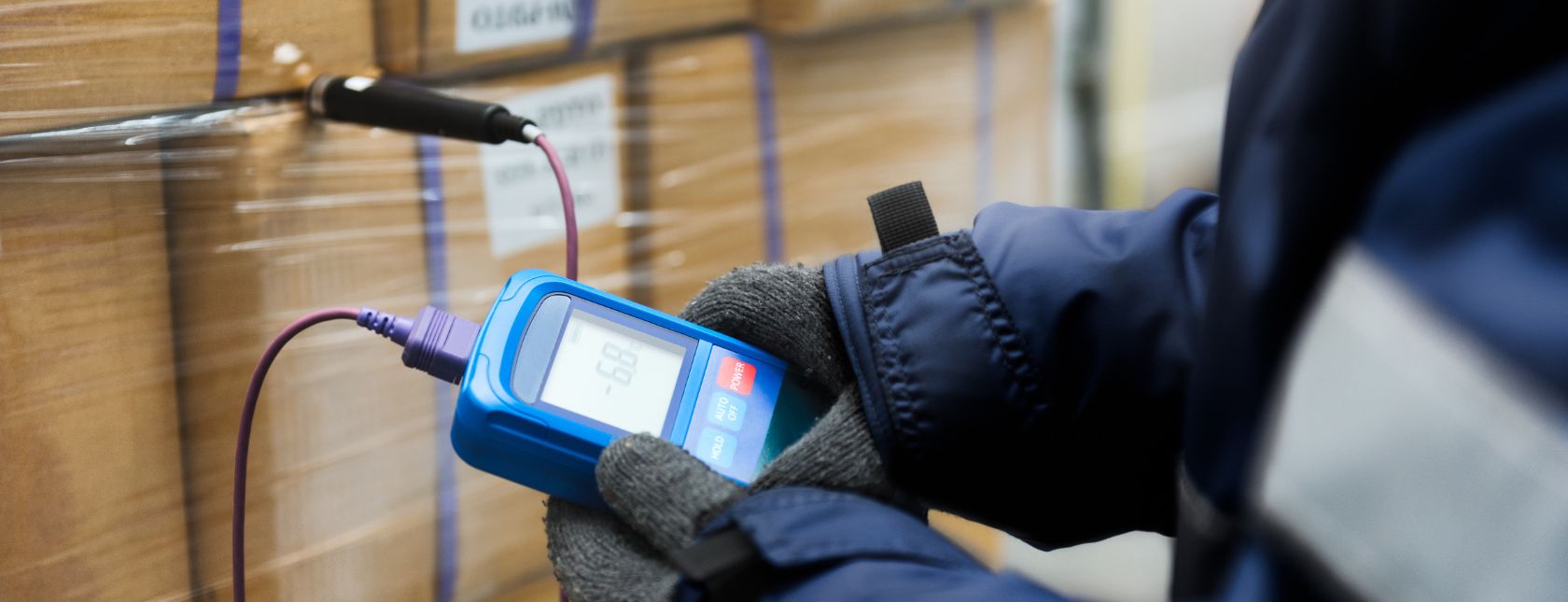 Hand of worker using thermometer to temperature measurement